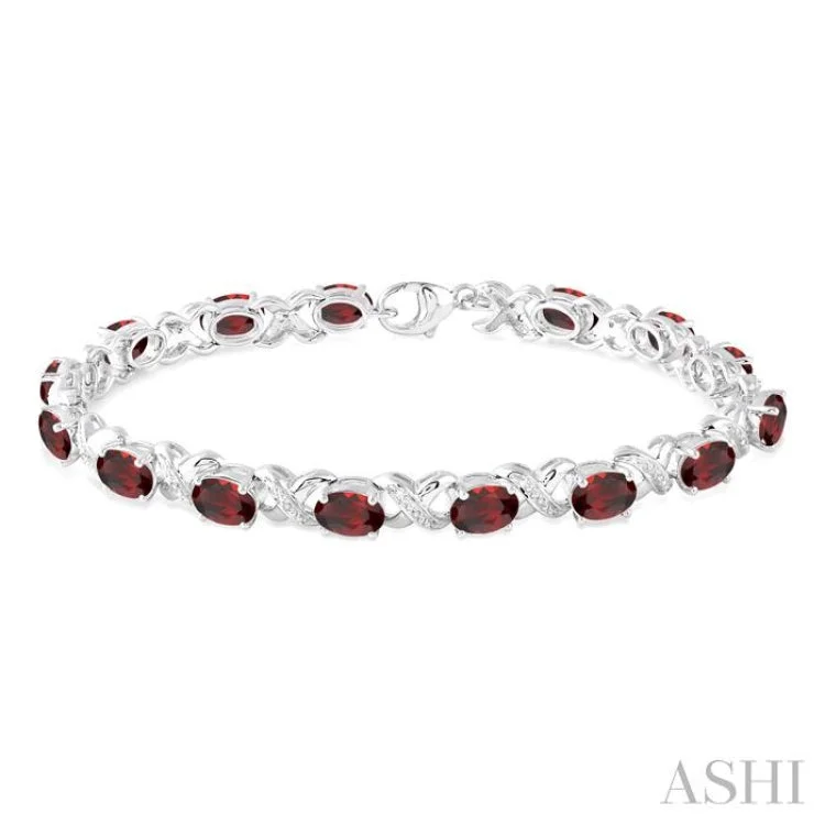 7x5 mm Oval Cut Garnet and 1/20 Ctw Round Cut Diamond Fashion Bracelet in Sterling Silver